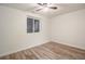 A bright bedroom with ceiling fan, a window and wood-look floors at 1145 Rosemary St # 105, Denver, CO 80220