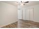 A bedroom with neutral walls, wood-look flooring, closet, and a ceiling fan at 1145 Rosemary St # 105, Denver, CO 80220