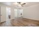 Bedroom with laminate flooring, fresh paint, and access to the bath, closet, and another room at 1145 Rosemary St # 105, Denver, CO 80220