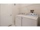 Practical laundry room featuring washer, dryer hookups, and a storage shelf at 1145 Rosemary St # 105, Denver, CO 80220