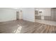 Bright living room featuring modern gray flooring and neutral walls, opening to an updated kitchen at 1145 Rosemary St # 105, Denver, CO 80220