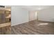 Open-concept living space with durable gray laminate floors and freshly painted neutral walls at 1145 Rosemary St # 105, Denver, CO 80220