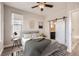 Cozy bedroom with a barn door and ceiling fan at 8642 E 47Th Ave, Denver, CO 80238