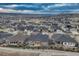 Aerial view of community homes with manicured lawns, mountain scenery, and cloud filled sky at 788 Alumroot St, Castle Rock, CO 80104