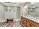 Modern bathroom with double vanity, large mirror and a glass enclosed shower at 788 Alumroot St, Castle Rock, CO 80104
