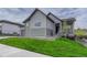 Two-story home with stone accents, a well-manicured lawn and inviting front porch at 788 Alumroot St, Castle Rock, CO 80104