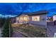 Home exterior showcasing a covered porch and well-maintained lawn at twilight at 788 Alumroot St, Castle Rock, CO 80104