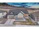 Charming home boasts a two-car garage and inviting front porch, set against a scenic hillside backdrop at 788 Alumroot St, Castle Rock, CO 80104