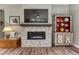 Living room fireplace and shelving, hardwood floors, and designer touches at 788 Alumroot St, Castle Rock, CO 80104