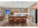 Modern kitchen with wood cabinets, island seating, and stainless steel appliances at 788 Alumroot St, Castle Rock, CO 80104