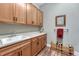 The laundry room has wooden cabinets, a utility sink, and wine storage racks at 788 Alumroot St, Castle Rock, CO 80104