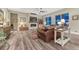 Cozy living room with a fireplace, hardwood floors, and large windows at 788 Alumroot St, Castle Rock, CO 80104