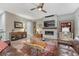 Relaxing living room featuring a fireplace, TV, and comfortable leather sofas at 788 Alumroot St, Castle Rock, CO 80104