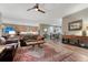 Spacious living room with wood floors, leather sofas, area rug, and views to kitchen at 788 Alumroot St, Castle Rock, CO 80104