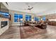 Open-concept living room featuring a stone fireplace, hardwood floors, and ample seating at 788 Alumroot St, Castle Rock, CO 80104