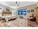 Comfortable main bedroom featuring wood floors, neutral walls, ceiling fan and warm decor and lots of light at 788 Alumroot St, Castle Rock, CO 80104