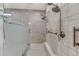 A shower room featuring dual shower heads, tiled walls and floors, and accessibility options at 788 Alumroot St, Castle Rock, CO 80104