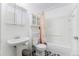 Bright bathroom featuring a tub with shower, toilet, vanity, and storage cabinet at 19707 E Princeton Pl, Aurora, CO 80013