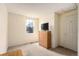 Neutral bedroom with large window, chest of drawers and closet door at 19707 E Princeton Pl, Aurora, CO 80013
