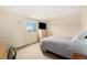 Sunlit bedroom with bed, dresser, and large window with views at 19707 E Princeton Pl, Aurora, CO 80013