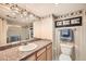 Bathroom featuring granite countertops, a framed mirror and shower with glass door at 1551 Larimer St # 1402, Denver, CO 80202