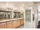 Bright bathroom featuring double sinks, vanity, tile floor and glass enclosed shower at 1551 Larimer St # 1402, Denver, CO 80202