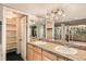 Bathroom featuring double sinks, vanity, and a door to a walk-in closet at 1551 Larimer St # 1402, Denver, CO 80202