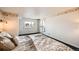 Bedroom with an exterior door, city views, and large comfortable bed at 1551 Larimer St # 1402, Denver, CO 80202