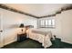Bedroom featuring single bed, city views from window, and ensuite bath at 1551 Larimer St # 1402, Denver, CO 80202