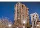 Stunning high-rise building with many floors and balconies against a blue sky at twilight at 1551 Larimer St # 1402, Denver, CO 80202