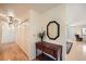 Bright hallway featuring beautiful hardwood floors, a wooden console table, and closet for storage at 1551 Larimer St # 1402, Denver, CO 80202