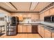 Bright kitchen features stainless appliances, wood floors, light cabinets and granite countertops at 1551 Larimer St # 1402, Denver, CO 80202