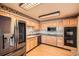 Well-lit kitchen featuring stainless steel appliances, granite countertops, and bright wood cabinets at 1551 Larimer St # 1402, Denver, CO 80202