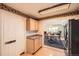 Kitchen with granite counters, stainless appliances, wood cabinets with open view to the dining and living room at 1551 Larimer St # 1402, Denver, CO 80202