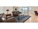Comfortable living room with hardwood floors, leather sofas, rug, and balcony with city views at 1551 Larimer St # 1402, Denver, CO 80202
