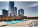 Outdoor rooftop pool area with lounge chairs and city skyline views at 1551 Larimer St # 1402, Denver, CO 80202