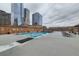 Rooftop pool with lounge chairs and stunning city views at 1551 Larimer St # 1402, Denver, CO 80202