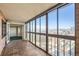 Sunroom with brick floors, floor-to-ceiling windows, city views, and access to the bedroom at 1551 Larimer St # 1402, Denver, CO 80202