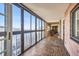 Sunroom featuring floor-to-ceiling windows with city views and brick accent wall at 1551 Larimer St # 1402, Denver, CO 80202