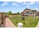 Expansive backyard with lush green lawn, privacy fence, and mature landscaping at 2043 S Cathay Way, Aurora, CO 80013