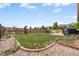 Spacious backyard featuring a well-maintained lawn, perimeter landscaping, and privacy fence at 2043 S Cathay Way, Aurora, CO 80013