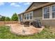 A cozy backyard patio space with a gas grill and outdoor furniture; perfect for entertaining at 2043 S Cathay Way, Aurora, CO 80013