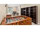Basement recreation area featuring a foosball table, desk, and storage shelving at 2043 S Cathay Way, Aurora, CO 80013