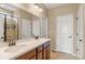 Clean and functional bathroom with double sinks, and a glass enclosed shower at 2043 S Cathay Way, Aurora, CO 80013