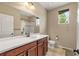 Clean bathroom featuring a vanity, toilet, shower-tub combo and window at 2043 S Cathay Way, Aurora, CO 80013