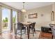 Bright dining room with hardwood floors, natural light, and a sliding glass door to the backyard at 2043 S Cathay Way, Aurora, CO 80013