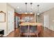 Spacious kitchen with wood cabinets, granite countertops, stainless steel appliances and an island with seating at 2043 S Cathay Way, Aurora, CO 80013