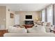 Cozy living room with hardwood floors, plush seating, and natural light at 2043 S Cathay Way, Aurora, CO 80013