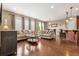 Spacious living room featuring hardwood floors, comfortable sofas, and large windows at 2043 S Cathay Way, Aurora, CO 80013