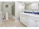 Bathroom features double sinks, tile floors and a shower with glass doors at 9630 W 38Th Ave, Wheat Ridge, CO 80033
